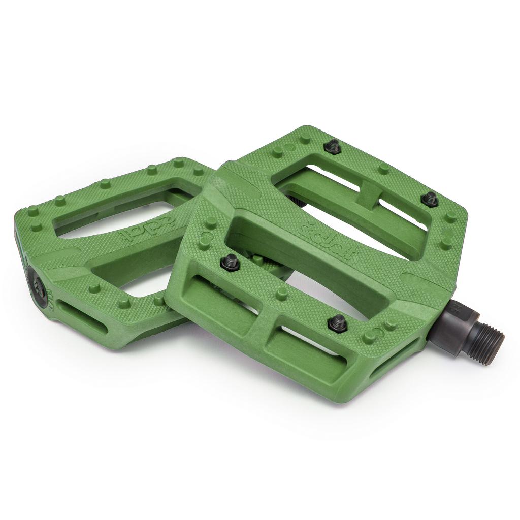 A pair of green Eclat Contra Pedals with a low-profile design, customizable metal pin grip, and textured surfaces are displayed side by side on a white background.