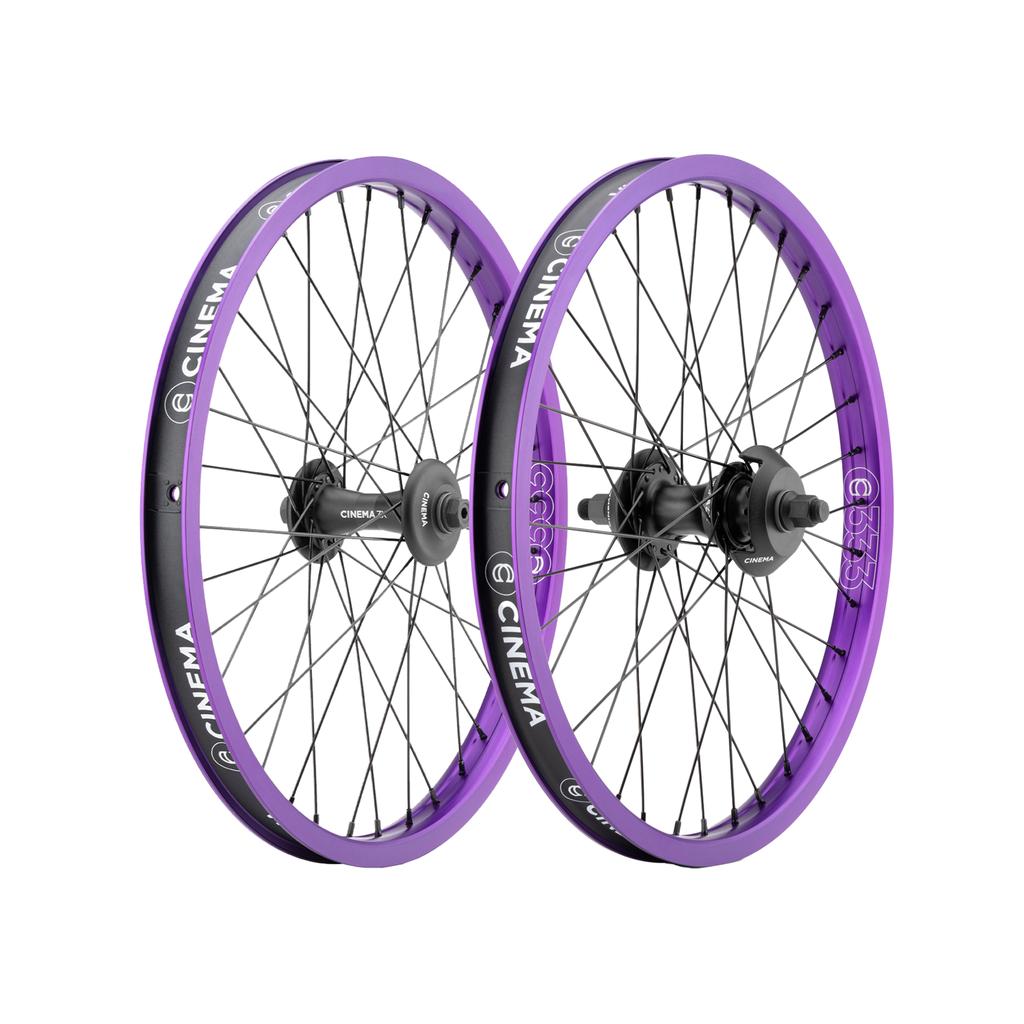 Cinema 333/ZX 20 Inch Wheel Set consisting of two 20-inch BMX bicycle wheels with purple rims, black spokes, and black hubs.