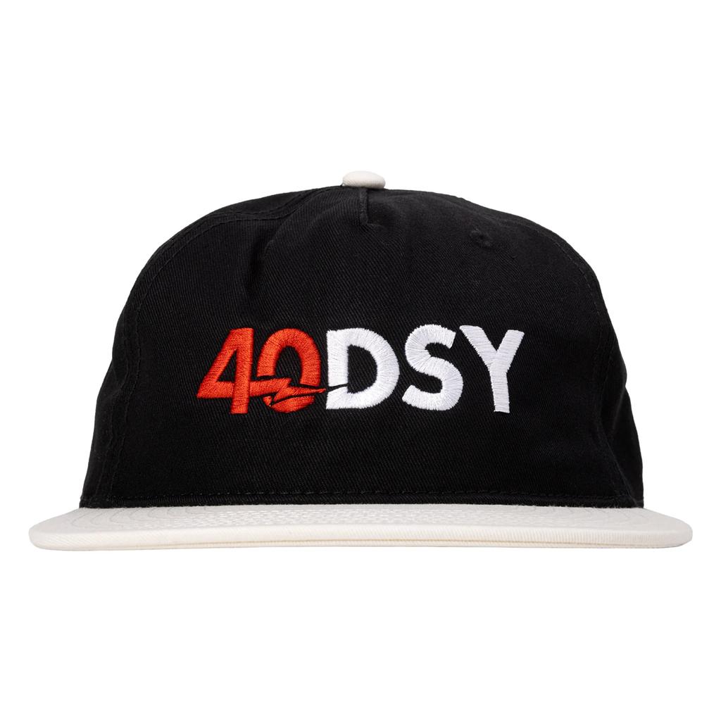 The Odyssey 40DSY Cap, in black and white, features "40DSY" boldly embroidered in red and white—ideal for your holiday lineup or any modern journey.