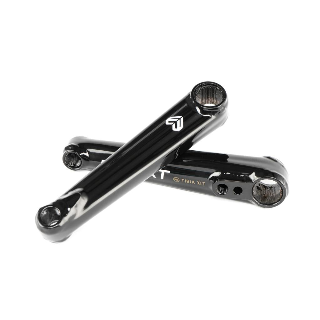 Two black Eclat Tibia XLT Cranks arms are crossed on a white background, highlighting their logo and sleek, lightweight design.