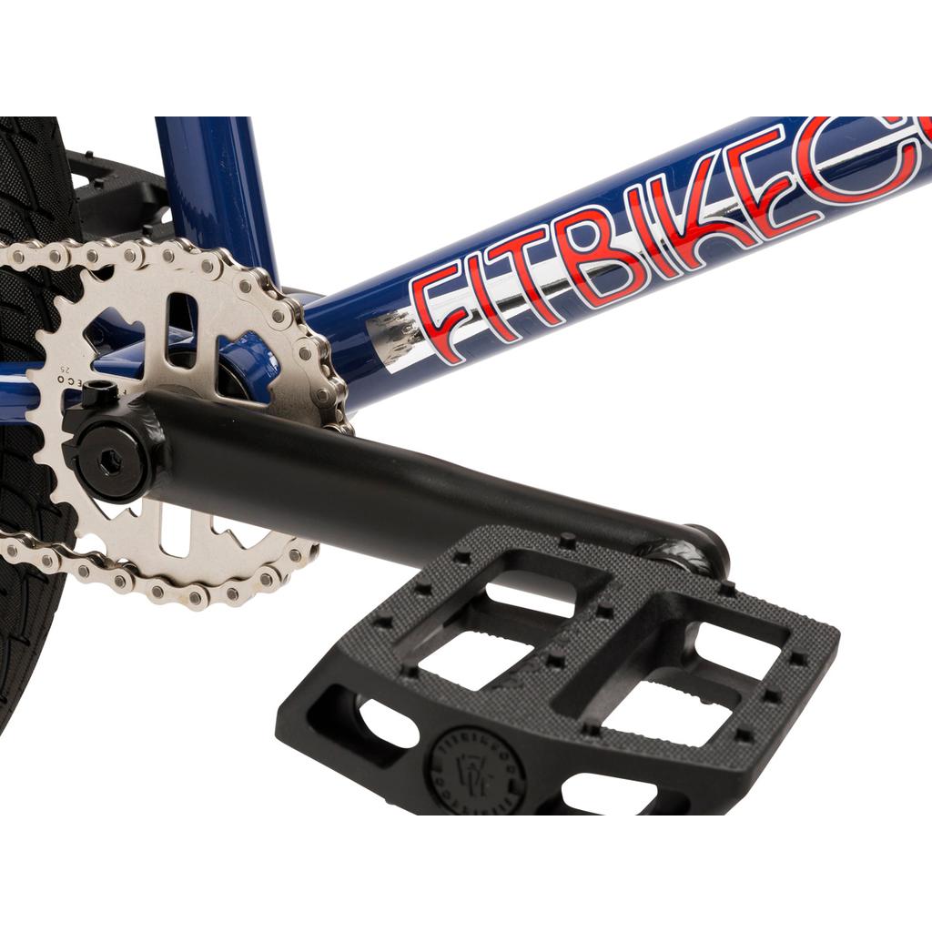 Close-up of a crankset, chainring, and black pedal on a blue Fit Bike Co PRK 20 Inch BMX with "FITBIKECO" text and a short top tube.