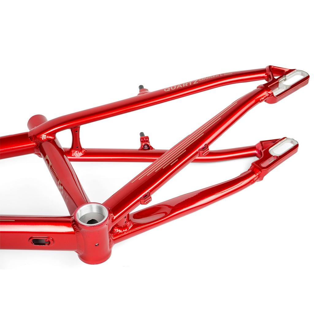Close-up of the Radio Raceline Quartz 2025 Pro XL Cruiser Frame in red metallic aluminum, highlighting the rear triangle, sliding dropout disc system, visible welds, and mounting points typical of BMX race bikes.