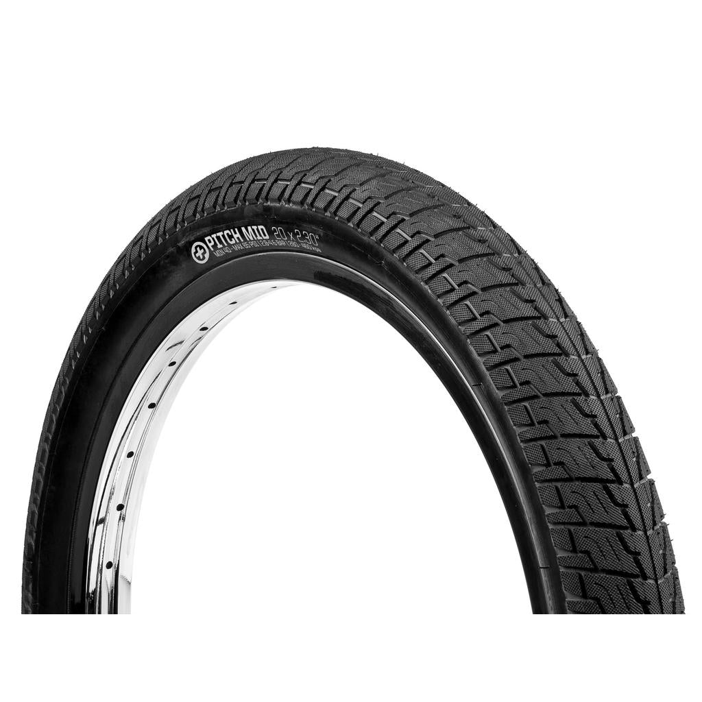 The Salt Pitch Mid 20 Inch Tyre, featuring a black knobbly tread, is fitted to a silver rim and displayed at an angle against a white background.
