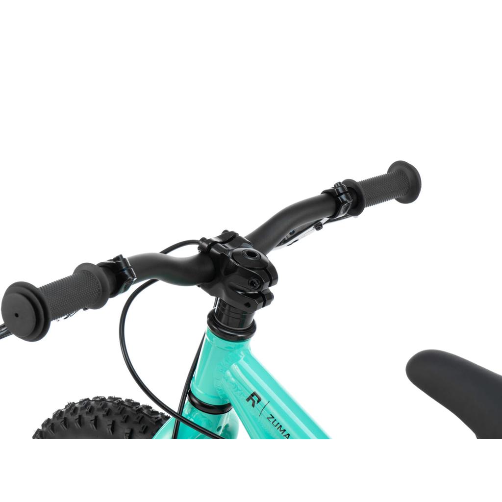 Close-up view of the Radio Zuma 14 Inch Bike’s turquoise handlebars, front fork, and part of the front wheel with knobby tread.