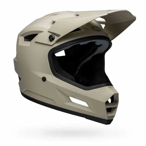 The Bell Sanction 2 Matte Cement is an entry-level, matte beige full-face helmet with visor and vents, ideal for BMX or motocross riders. Shown on a white background.