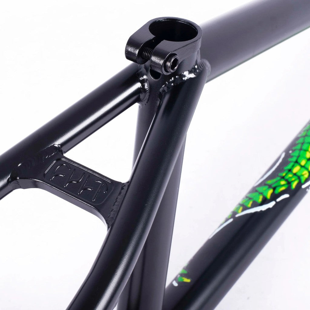A close up of a black bike frame with a green design, featuring the Cult Trey Jones Frame.