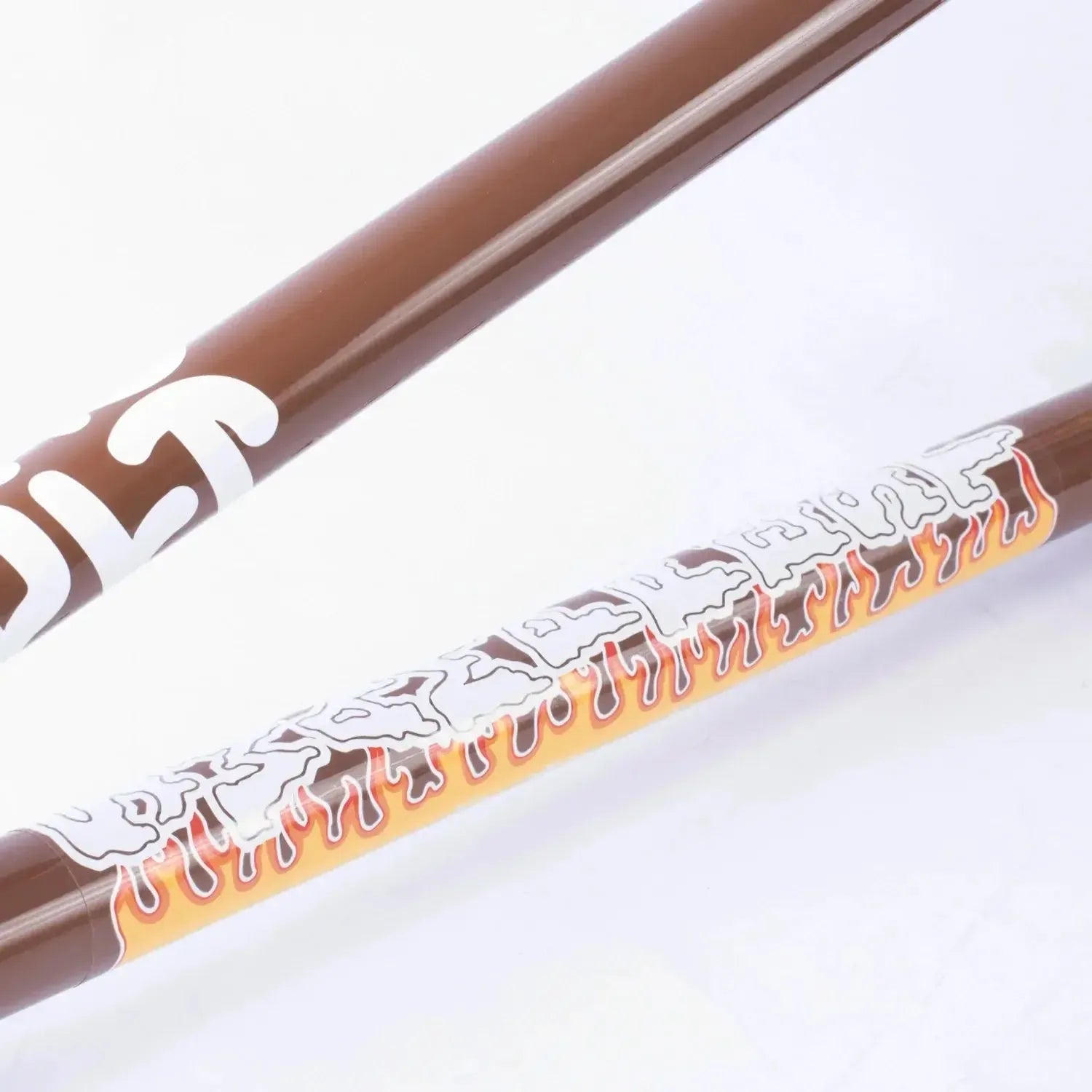 Close-up of two brown BMX frame tubes from the Cult Trey Jones Frame: one has a white logo, and the other shows "HAVE ALL THAT" in white with orange flames—part of the Trey Jones signature series.