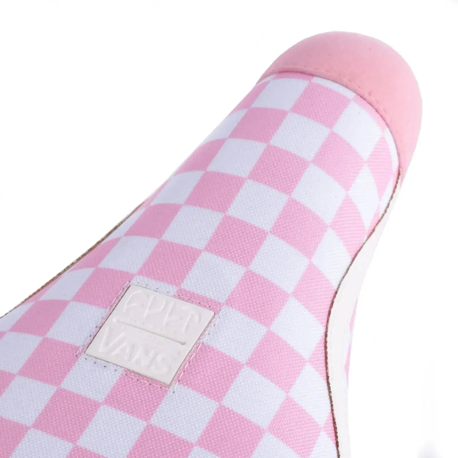 A close-up of the Cult Vans Old Skool Checker Pivotal Seat, a limited edition BMX seat with a pink and white checker pattern and signature Vans logo patch.