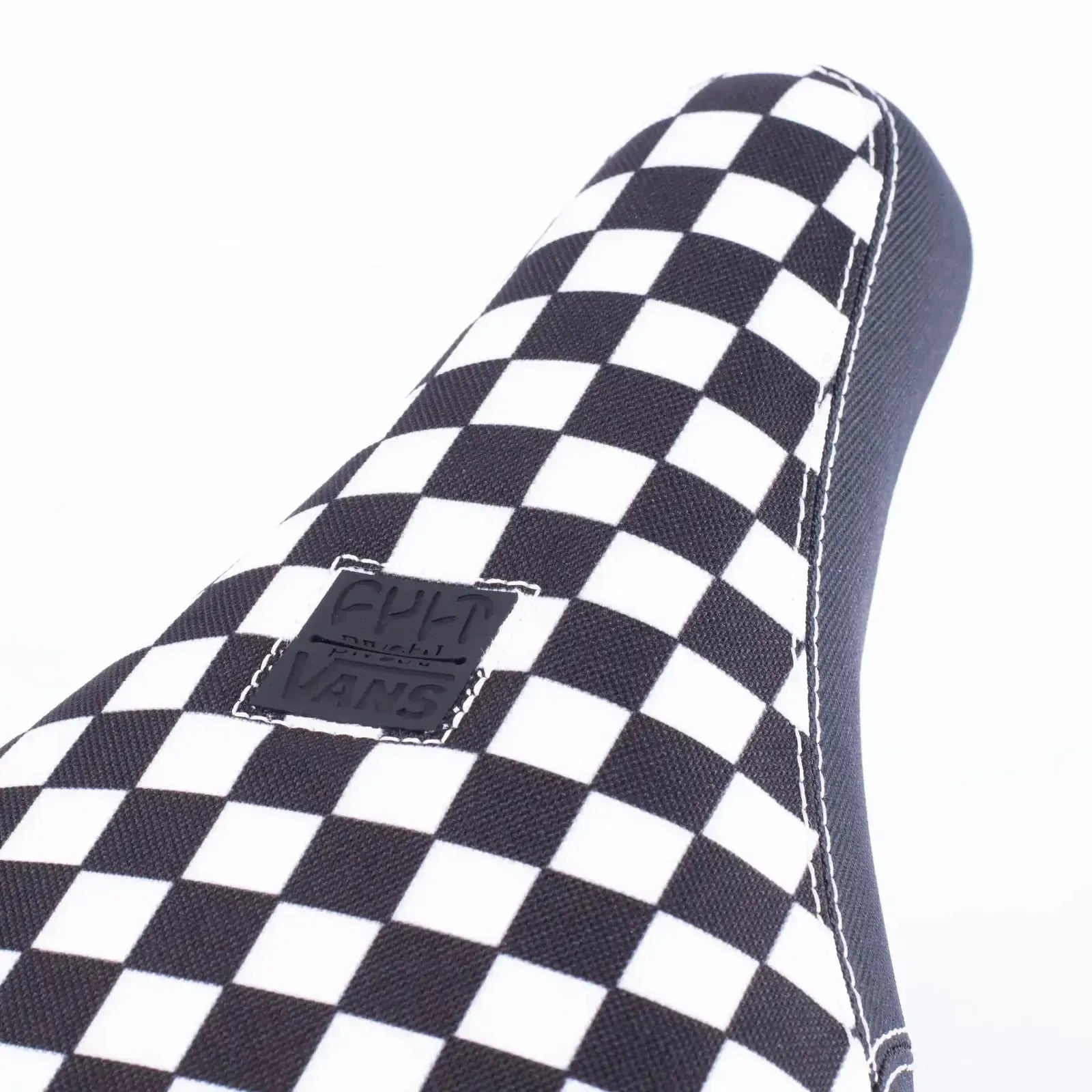Close-up of the Cult Vans Slip On Checker Pivotal Seat, showcasing its limited edition checkered pattern and a small Vans logo patch.