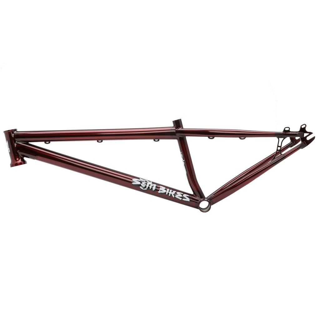 The S&M Big Jumper 26 Inch Dirt Jumper Frame is a metallic red bike frame with a triangular design, S&M Bikes logo, and mounts for disc brake components.