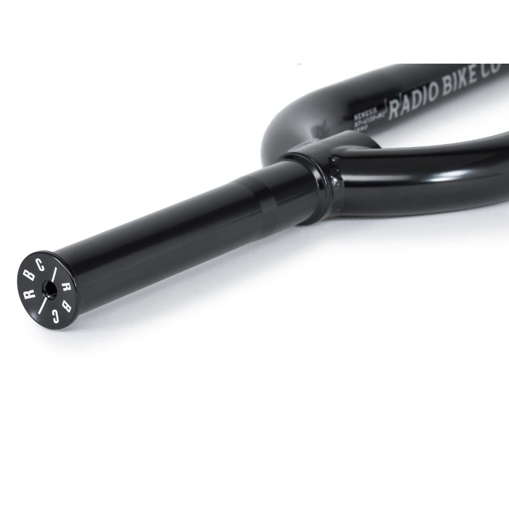 Close-up of the Radio Nemesis Forks with "RADIO BIKE CO." branding and "RBC" on the end cap, featuring a heat-treated chromoly build for a responsive front end, shown against a white background.