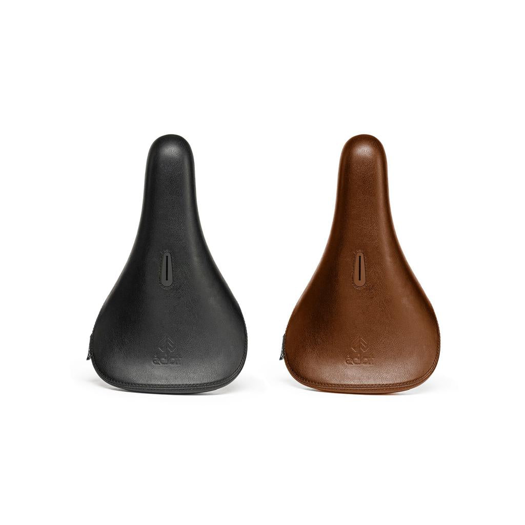 The Eclat Exile Pivotal Seats are shown side by side in black and brown, each with a simple design, ergonomic BMX seat shape, and a small logo near the front.