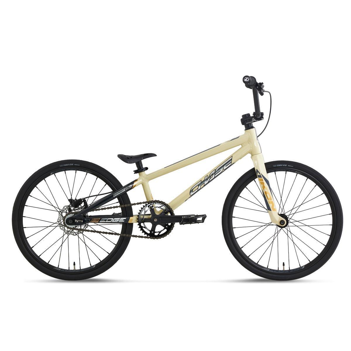 Tan Chase Edge Expert CF Race Bike (2027) with black wheels, handlebars, and disc brakes.
