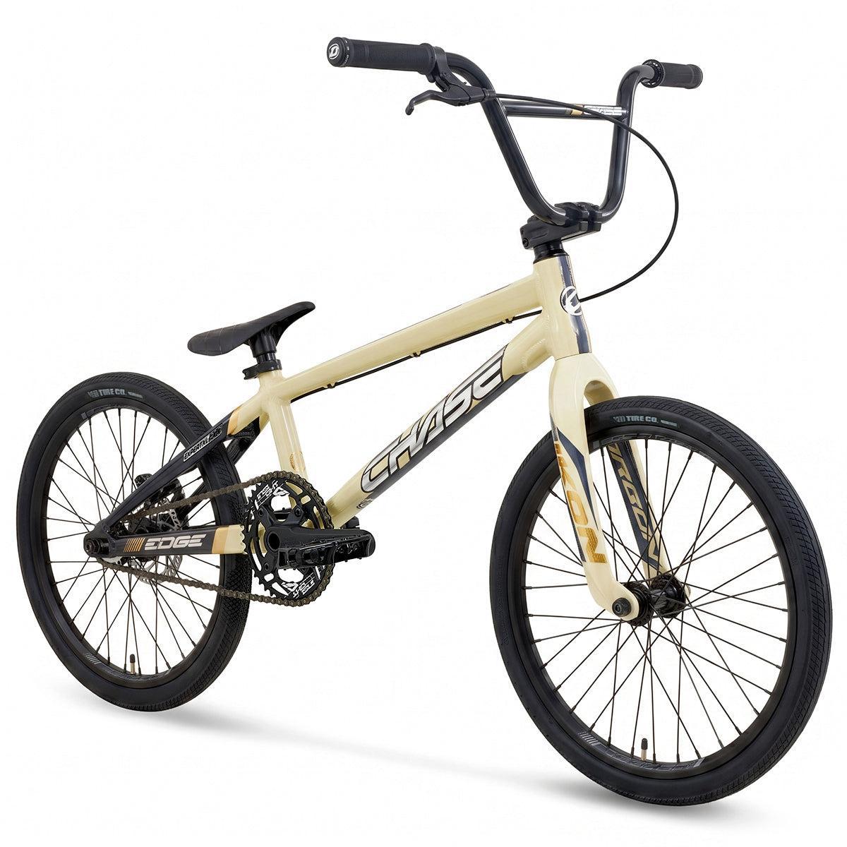 A tan Chase Edge Expert XL CF Race Bike (2027) with black handlebars, seat, and wheels, featuring the word “CHASE” on the frame. This model is equipped with a Chase Edge CF carbon fork for enhanced performance and control.
