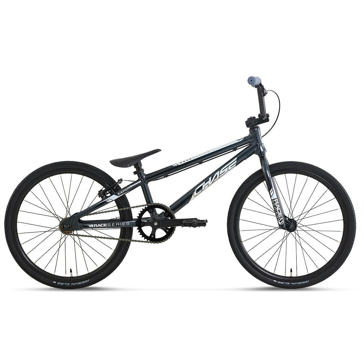 A Chase Race Series Expert Race Bike (2027) in black, featuring a lightweight frame, thin tires, flat handlebars, and a single gear, is shown in side profile on a white background—an excellent entry-level race bike for aspiring riders.
