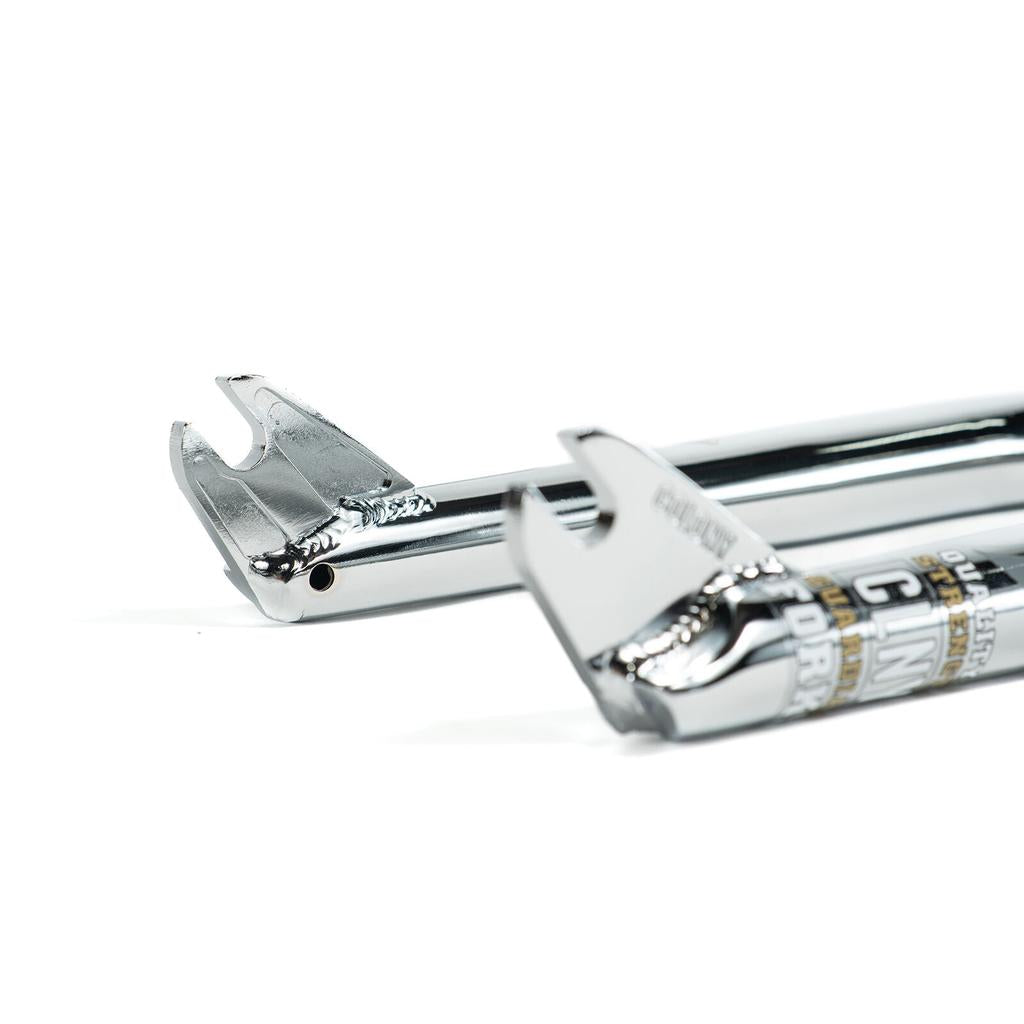 Two Colony Guardian 20 Inch Forks with dropouts facing the camera, made from strong 4130 CrMo. The polished chrome finish gleams, while a partial product label is visible on the right fork.