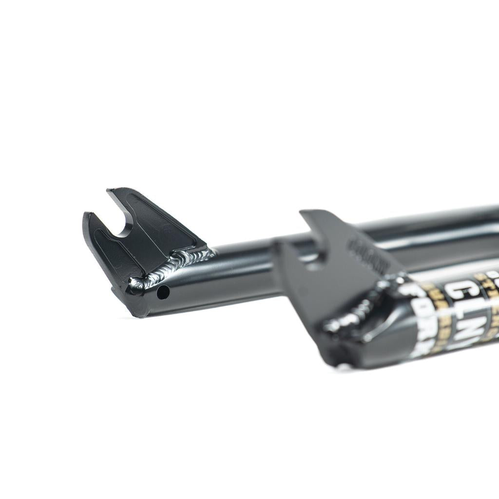 Close-up of a black Colony Guardian 20 Inch Fork dropout, showing detailed welds, fork blade branding, and front brake mounts for BMX compatibility.