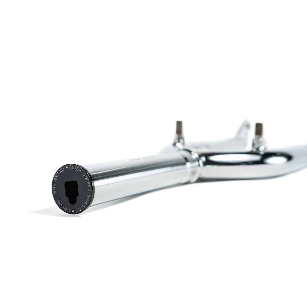 Close-up of a chrome Colony Guardian 20 Inch Fork with brake mounts, lying on a white surface and focusing on the branded end cap and hex key slot. This model is front brake compatible in the Guardian forks range.