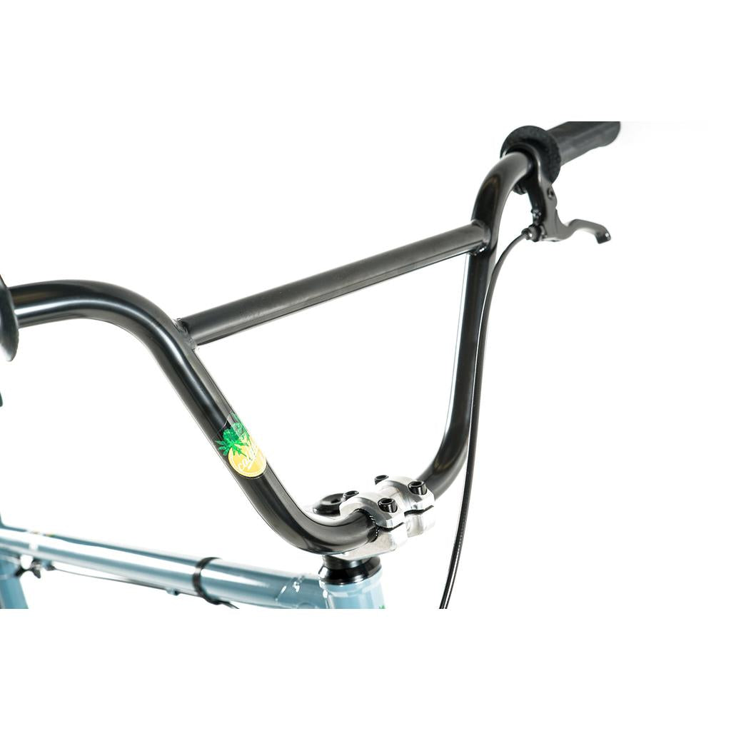 Close-up of the Colony Eclipse 26 Inch Bike’s BMX cruiser handlebar featuring a brake lever, stem, and a green sticker on the right side; parts are highlighted against a white background.