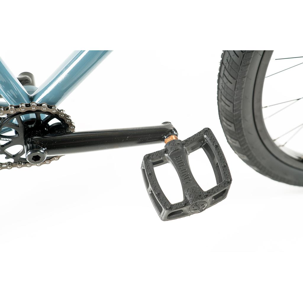 Close-up of the crank arm, chainring, and black pedal attached to the chromoly frame of the Colony Eclipse 26 Inch Bike, with part of the rear wheel and tire visible.