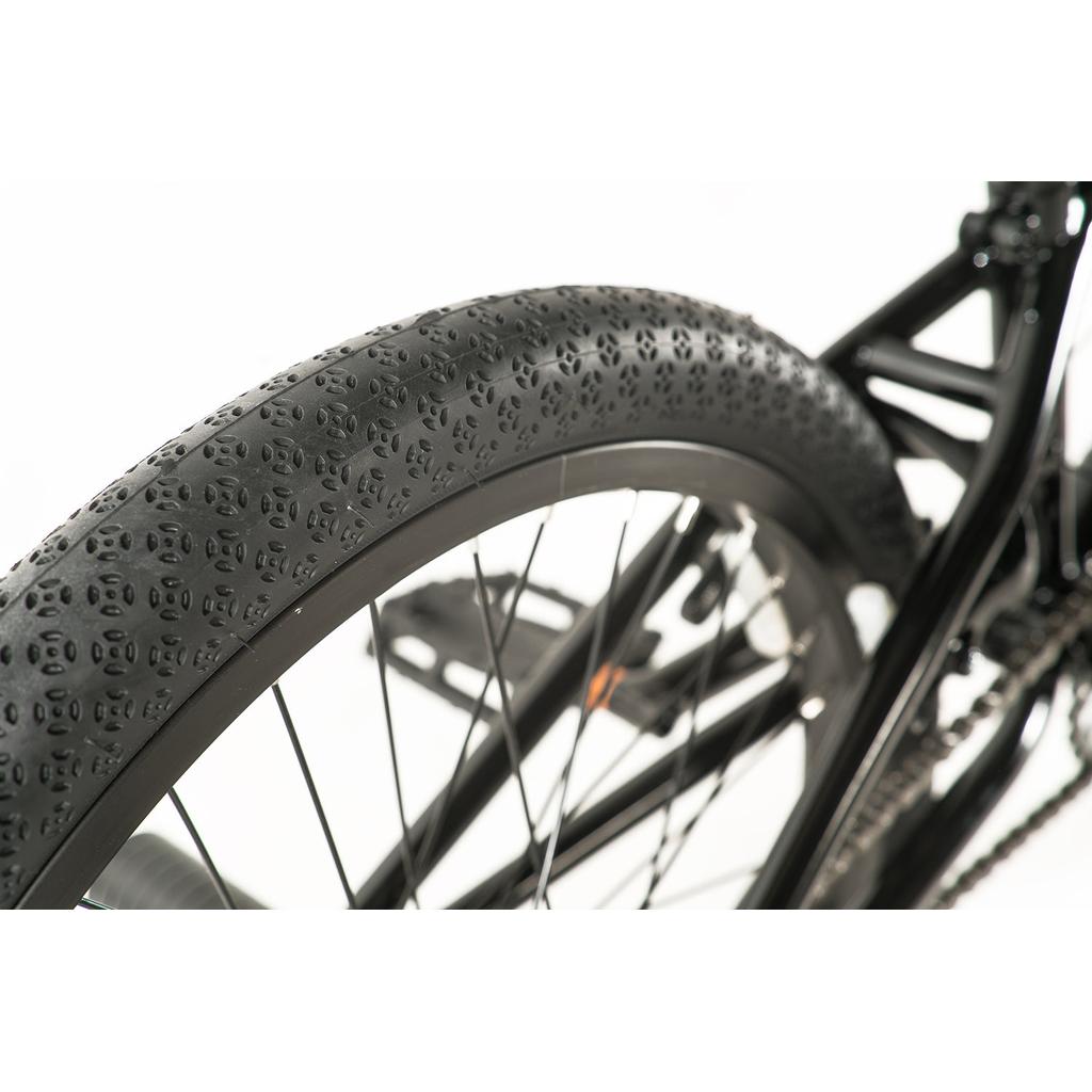 Close-up of the black rear tire, textured tread, spokes, pedal, and 18.9" frame of the Colony Apprentice Flatland 20 Inch Bike against a white background, highlighting its flatland BMX design.