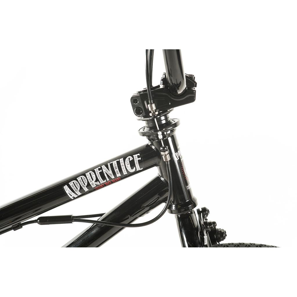 Close-up of the front section of the Colony Apprentice Flatland 20 Inch Bike in black, showing "APPRENTICE" on the top tube. This flatland BMX features an 18.9" frame for precision and style.