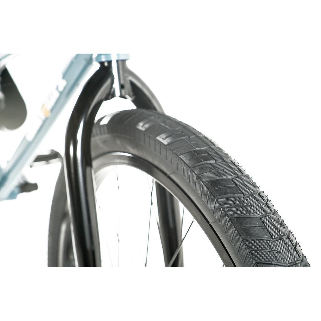 Close-up of the front tire and fork on the Colony Eclipse 24 Inch Bike, showing the tread pattern and a section of the chromoly frame against a white background.
