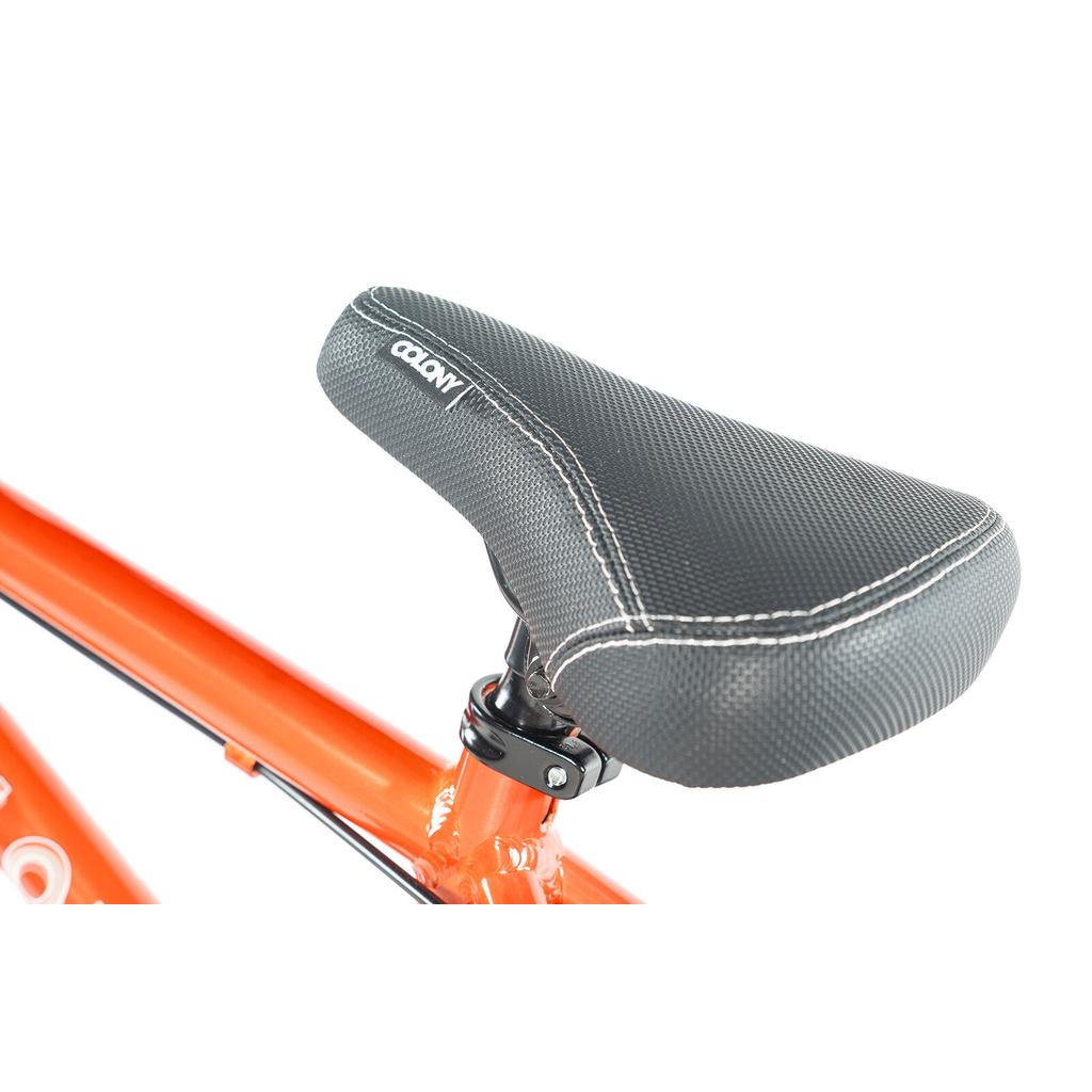 Close-up of a black textured seat with white stitching on the lightweight alloy frame of the Colony Horizon 14 Inch Bike, shown against a white background.