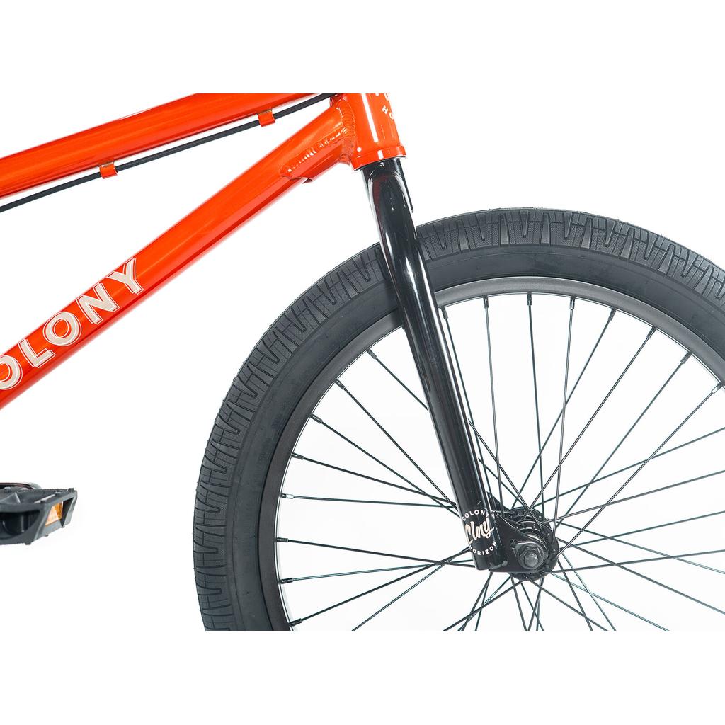 Close-up of the red Colony Horizon 20 Inch Bike, showcasing "COLONY" branding, a black fork, and a large black front wheel—ideal for aspiring freestyle Olympic athletes.