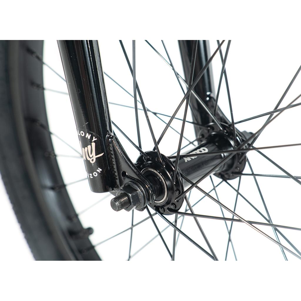 Close-up of the black front wheel hub, spokes, and fork with visible axle and nuts on the Colony Horizon 20 Inch Bike, a model trusted by BMX bikes and freestyle Olympic athletes for its reliability.