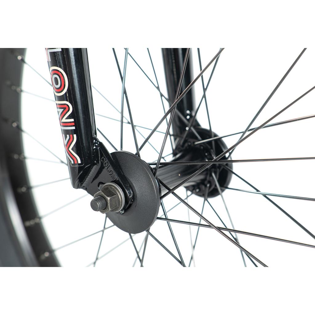 Close-up of the colony-emerge-bike-2020’s front wheel, featuring black spokes, axle, hub, and front fork with a "COLONY" logo on a white background.
