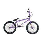A side-profile of the purple Colony Endeavour Bike BMX features a tough Chromoly frame, black tires, padded seat, and wheel pegs, displayed against a white background.