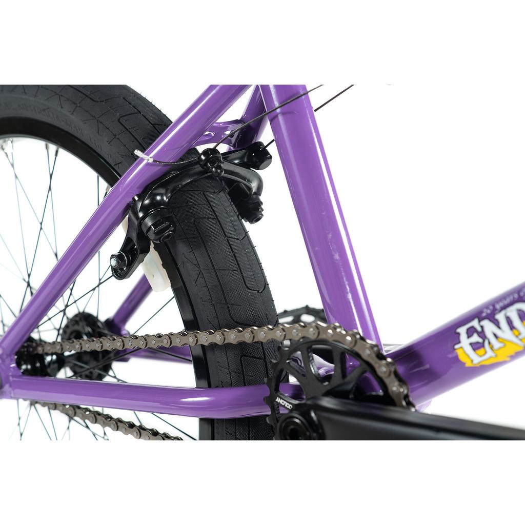 Close-up of the rear wheel, brake, and chain mechanism on the Colony Endeavour Bike in purple, set against a white background.