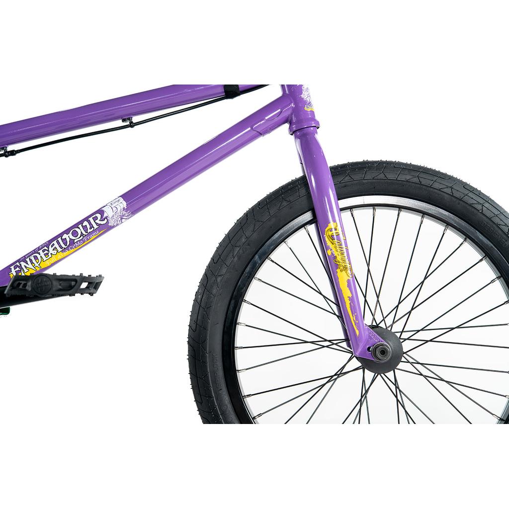 Close-up of the Colony Endeavour Bike in purple, highlighting its front wheel, fork, pedal, and Chromoly BMX frame with "ENDEAVOUR" text.