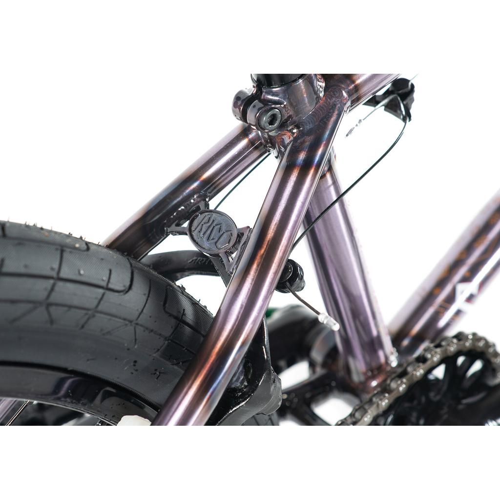 Close-up of the Colony Rico Elite 20 Inch Bike’s rear wheel, frame, and brake system, highlighting pro-level performance with metallic purple paint and a black treaded tire—showcasing the bike's precision engineering.