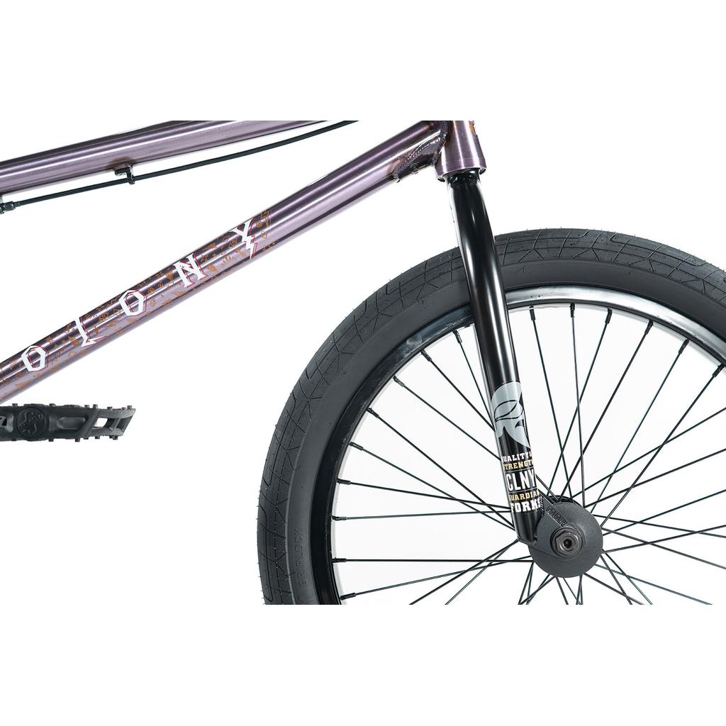 Close-up of the front wheel and frame of the Colony Rico Elite 20 Inch Bike, featuring black spokes, tire, pedal, and bold "COLONY" logo—crafted for pro-level BMX performance.