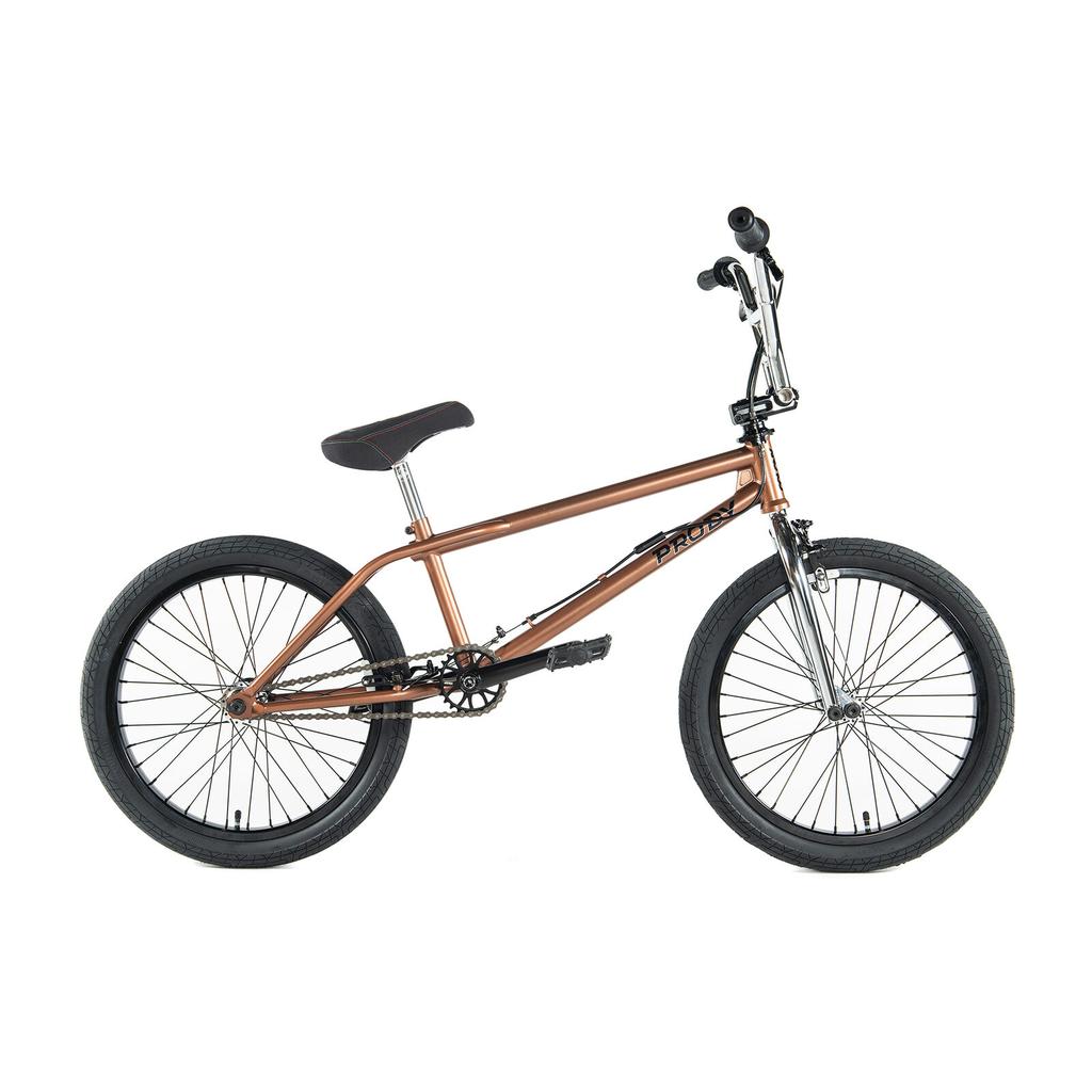 A brown Colony Prody Elite 20 Inch BMX bike with a CrMo frame, black tires and seat, and chrome handlebars is shown in side profile on a white background.