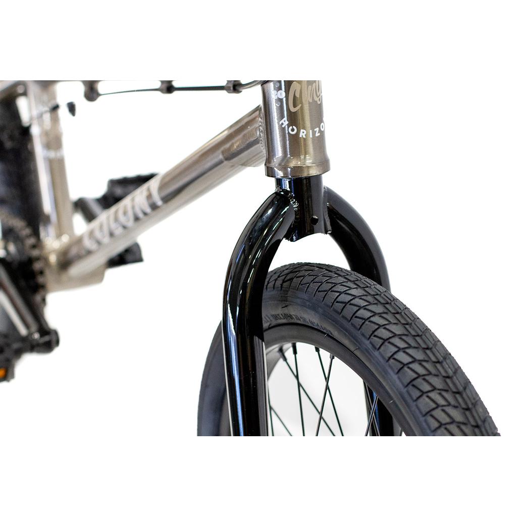 Close-up of the Colony Horizon 18 Inch Bike’s front wheel, black fork, and part of its lightweight alloy frame against a white background.