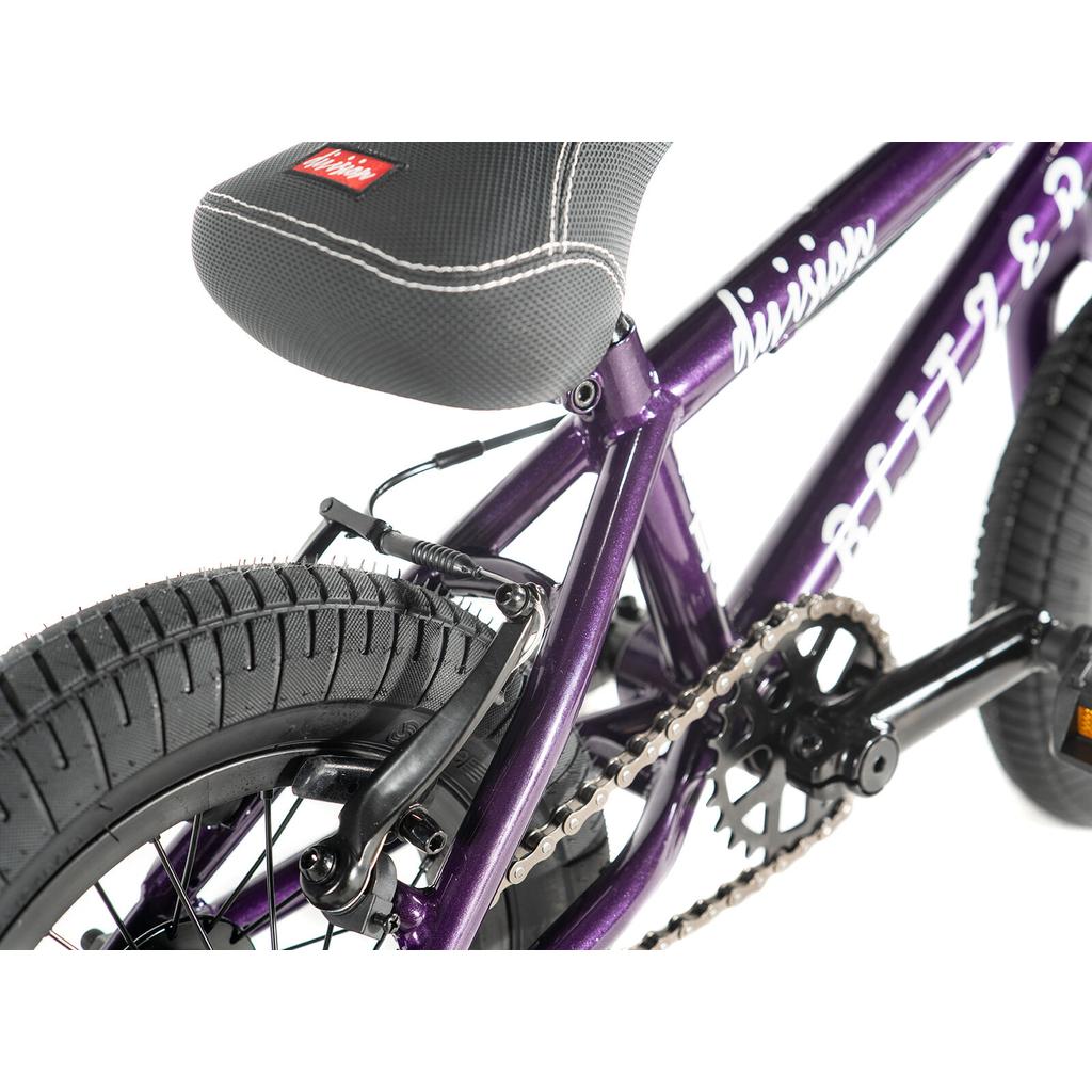 Close-up of the rear wheel, brake, chain, and seat of the Division Blitzer 12 Inch Bike in purple, showcasing detailed frame components designed for young riders.