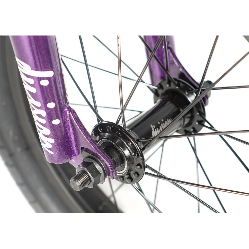 Close-up of the Division Blitzer 14 Inch Bike front wheel hub and axle, featuring black spokes and a purple “Mission” fork against a white background.