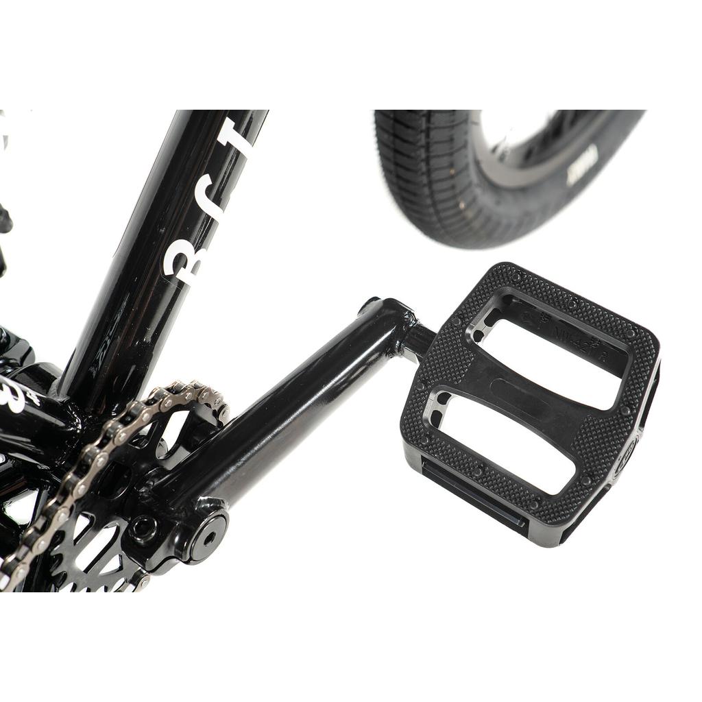 Close-up of a black pedal attached to the crank arm, with part of the chain and rear tire visible on the Division Blitzer 16 Inch Bike.