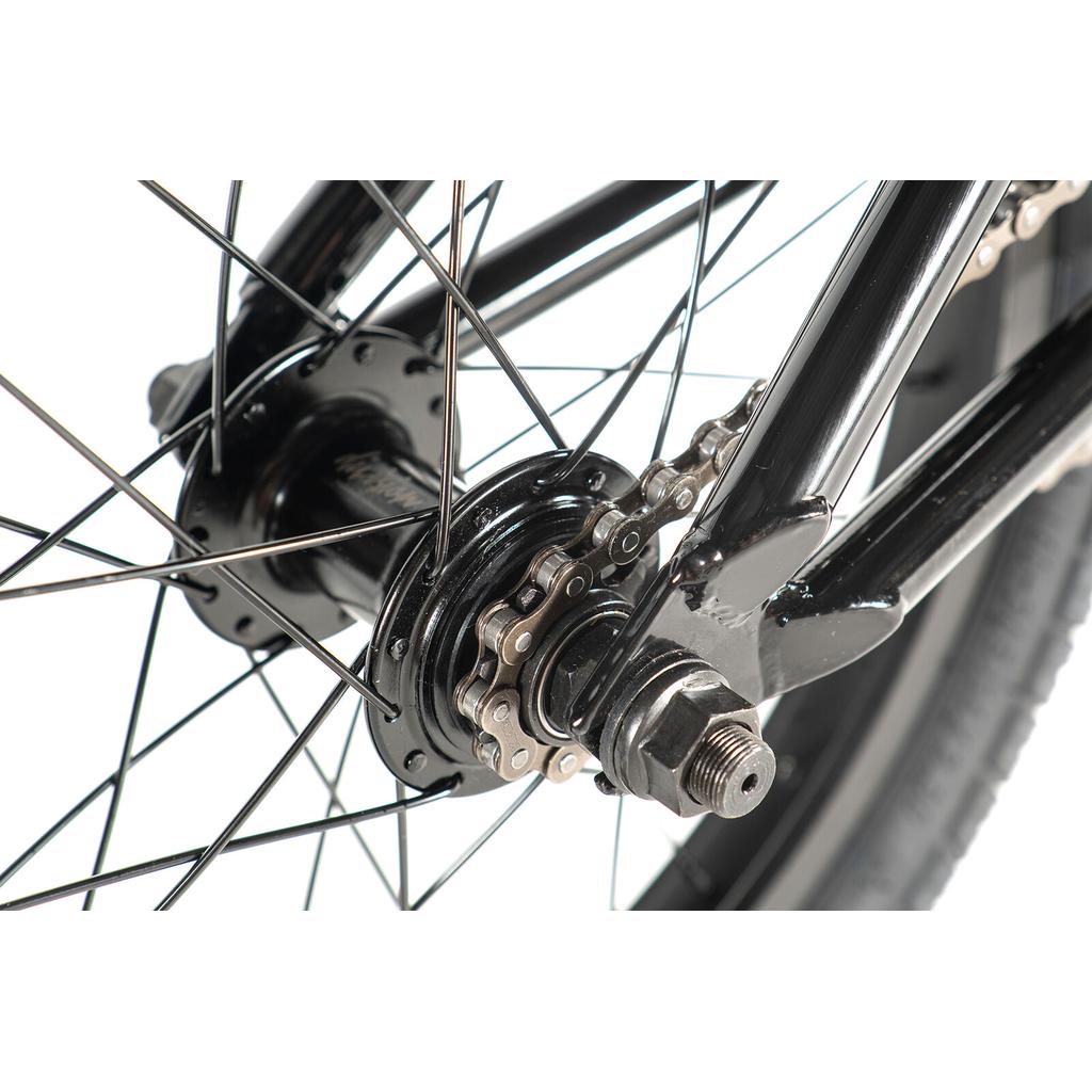 Close-up of the Division Blitzer 16 Inch Bike’s rear wheel, highlighting its metal hub, spokes, chain, and axle nut, set against a white background.