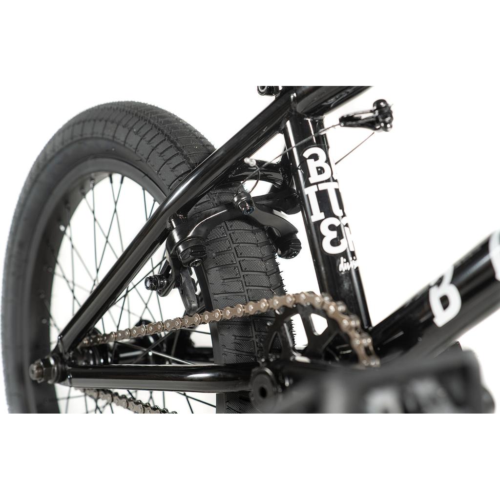 Close-up view of the rear wheel, tire, chain, and brake of the Division Blitzer 18 Inch Bike—a black BMX with white lettering that's ideal for kids starting out.