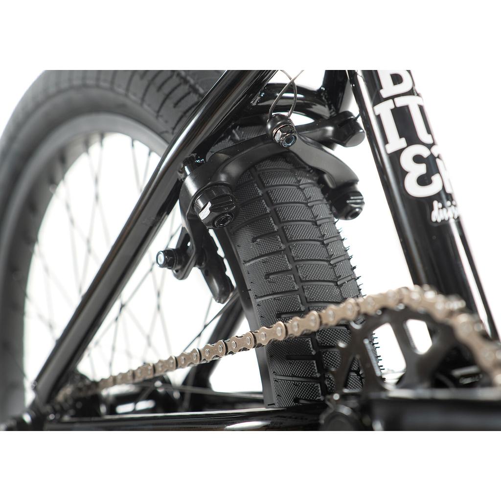 Close-up of the Division Blitzer 20 Inch Bike’s rear wheel, highlighting the 20” tire, chain, brake arms, and part of the frame.