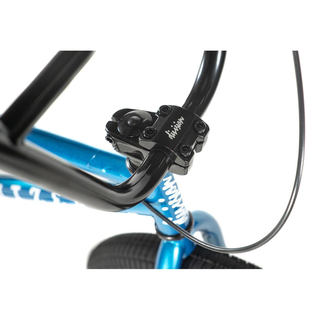Close-up of a black handlebar and stem on the Division Blitzer 20 Inch Bike, featuring a blue frame, visible brake cable, part of the front tire, and 20” wheels—ideal for beginner street BMX riders.