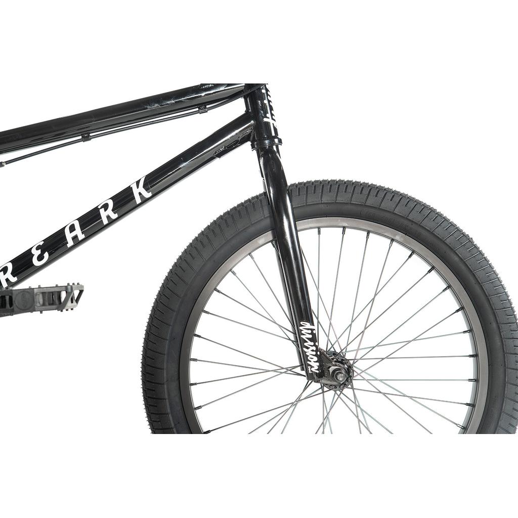 Close-up of the Division Reark 20 Inch Bike in black, showing the lightweight Hi-Tensile steel frame, handlebars, front fork, front wheel with tire, and visible white lettering on the frame.
