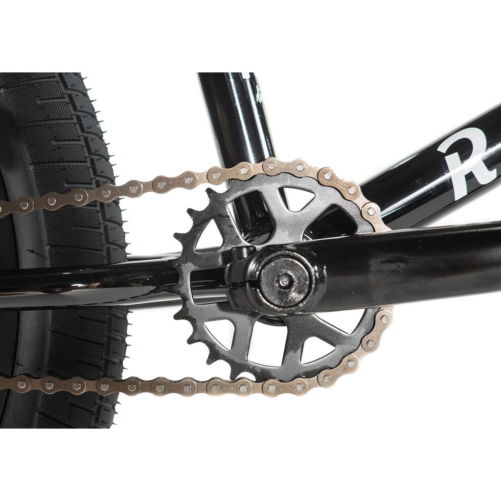 Close-up of the Division Reark 20 Inch Bike's rear wheel, chain, and sprocket attached to the 3-piece cranks, highlighting drivetrain components made from lightweight Hi-Tensile steel.