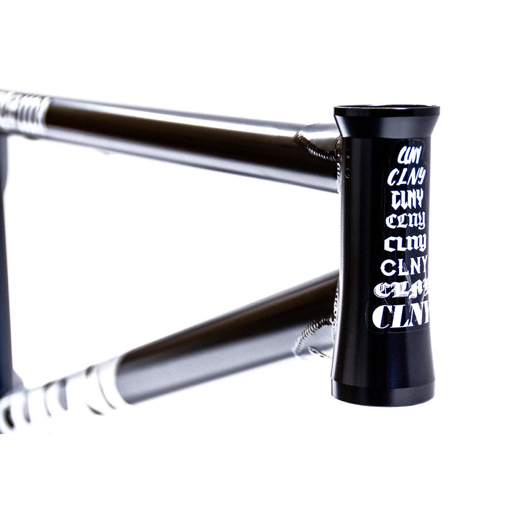 Close-up of the black Colony Prisma Frame's head tube, featuring "CLNY" in white fonts, showcasing its CrMo build and geometry designed for street BMX riding.