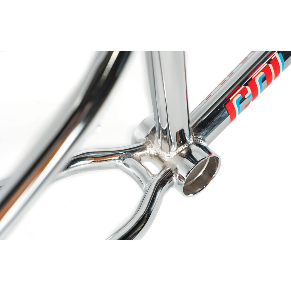 Close-up of a polished chrome Colony Enishi Flatland Frame (Kio Hayakawa Signature), highlighting the bottom bracket area and part of a red and blue decal.