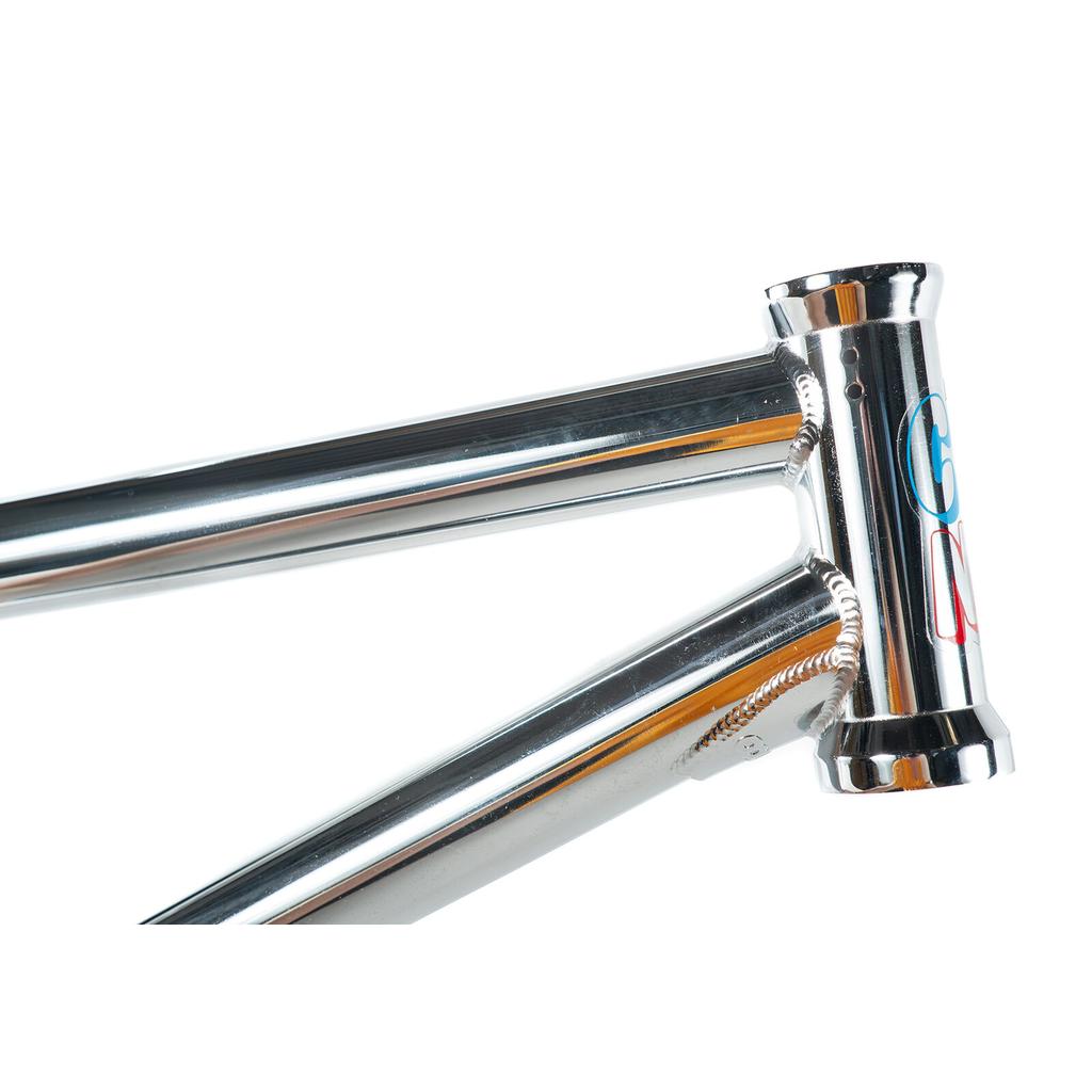 Close-up of the shiny chrome Colony Enishi Flatland Frame (Kio Hayakawa Signature) showing the top tube, down tube, and head tube with a colorful logo—built for flatland BMX performance.
